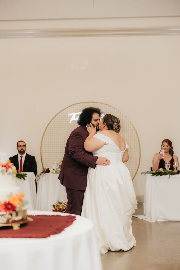 cute picture of the bride of the newly married couple kissing