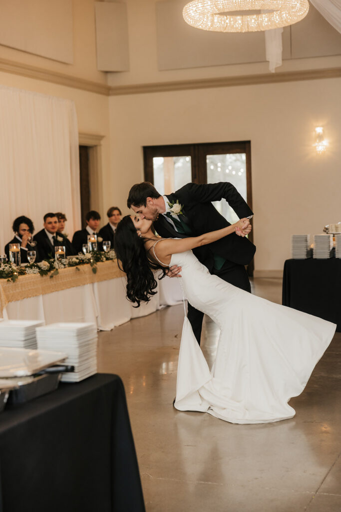 cute picture of the newlyweds kissing at their reception