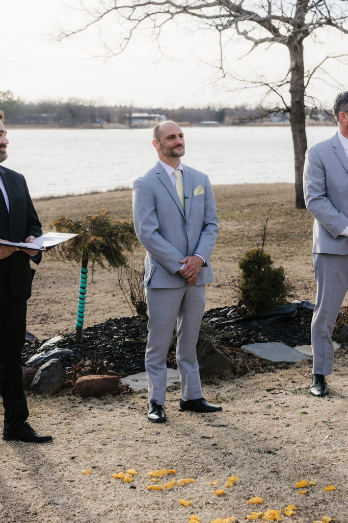 groom watching the bride walk down the aisle