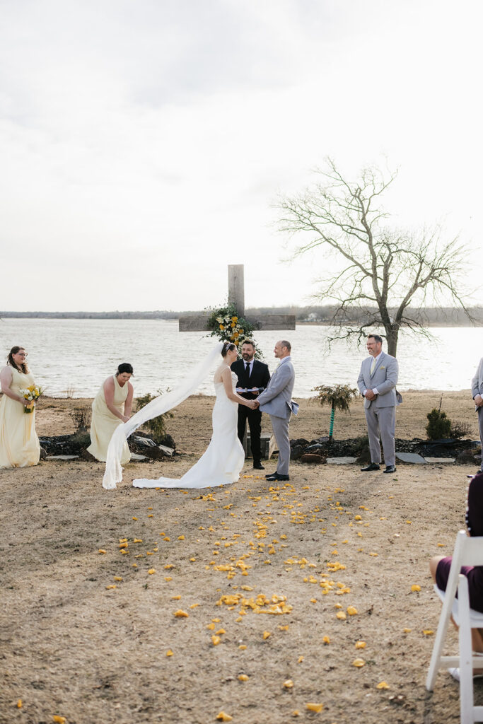 bride and groom holding hands during their wedding ceremony