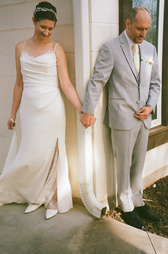 cute picture of the bride and groom holding hands