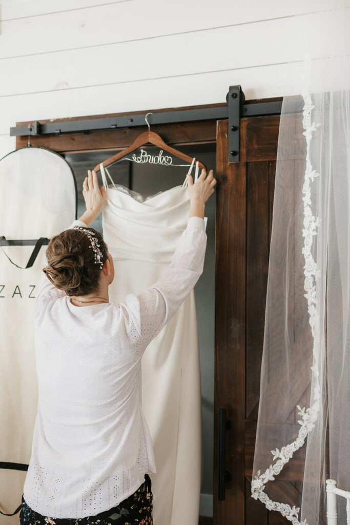 cute picture of the bride next to her wedding dress