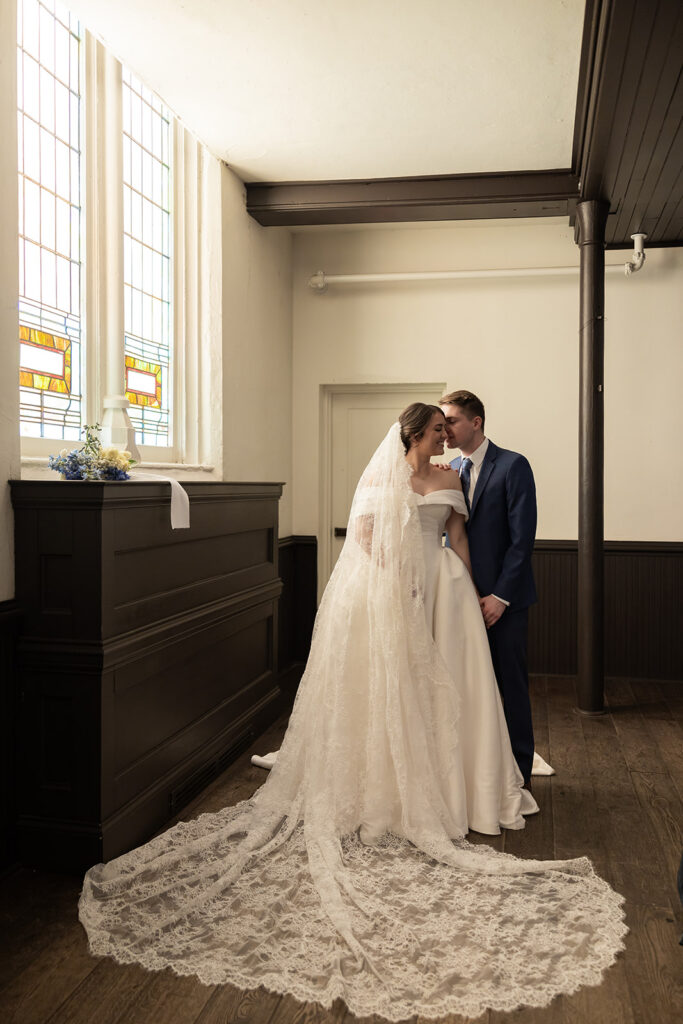groom kissing the bride on the cheek