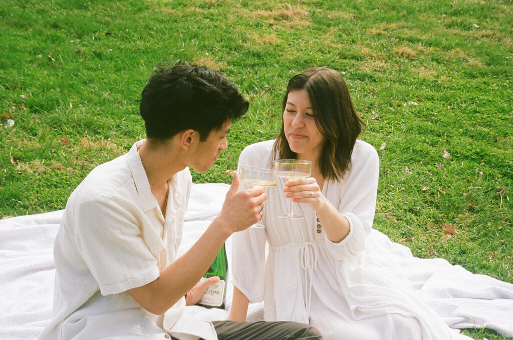 cute picture of the newly engaged couple celebrating with champagne