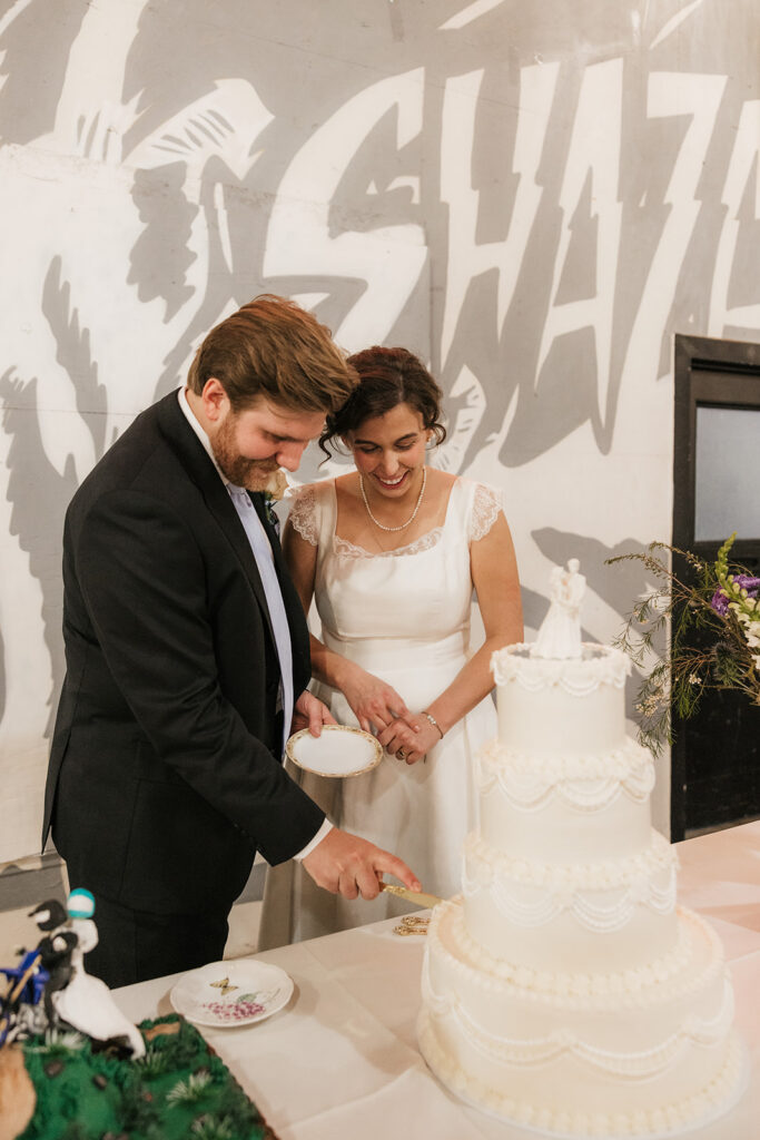 newlyweds cutting their wedding cake