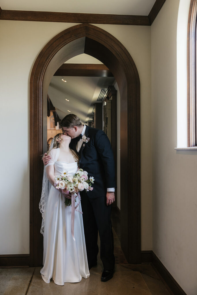 cute picture of the bride and groom kissing
