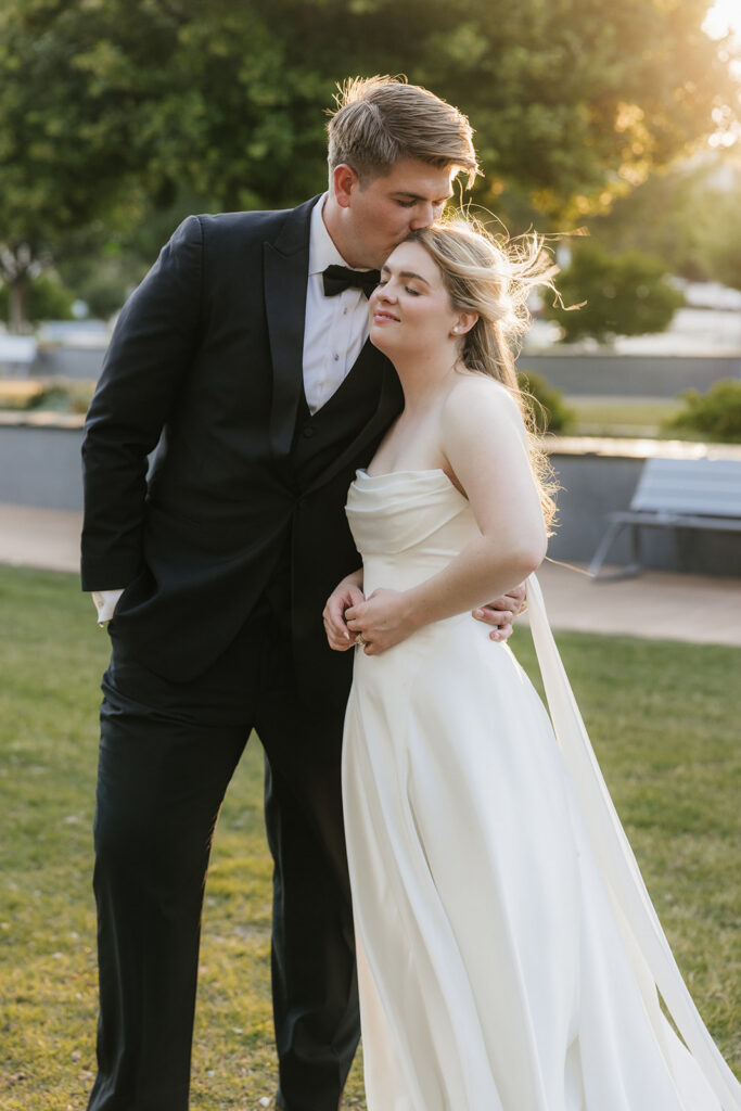 groom kissing the bride on the cheek