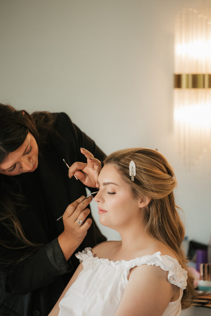 bride getting her makeup done for her dream wedding day