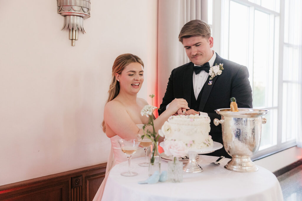cute picture of the newlyweds cutting their wedding cake