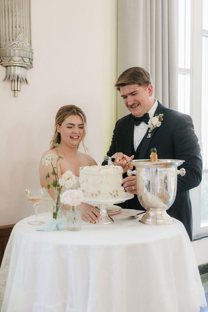 newlyweds trying their wedding cake