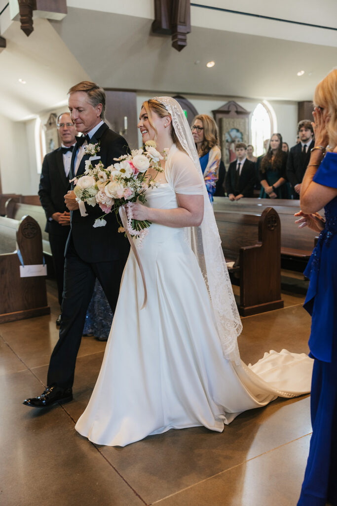 beautiful picture of the bride walking dow the aisle