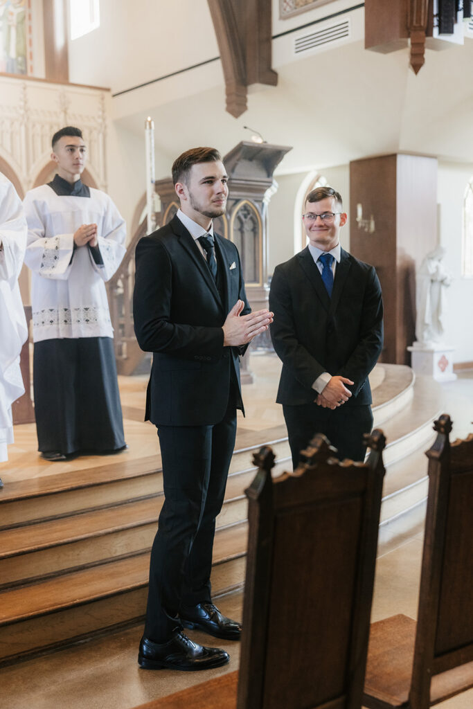 groom watching the bride walk down the aisle