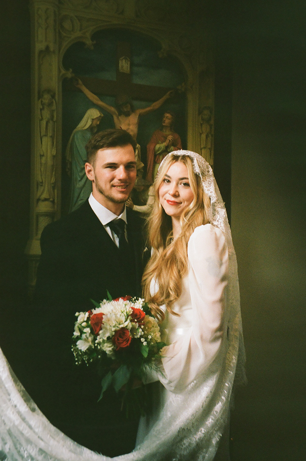 newlyweds smiling at the camera during their photoshoot