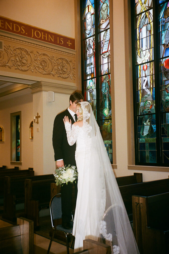 groom kissing the bride on the cheek