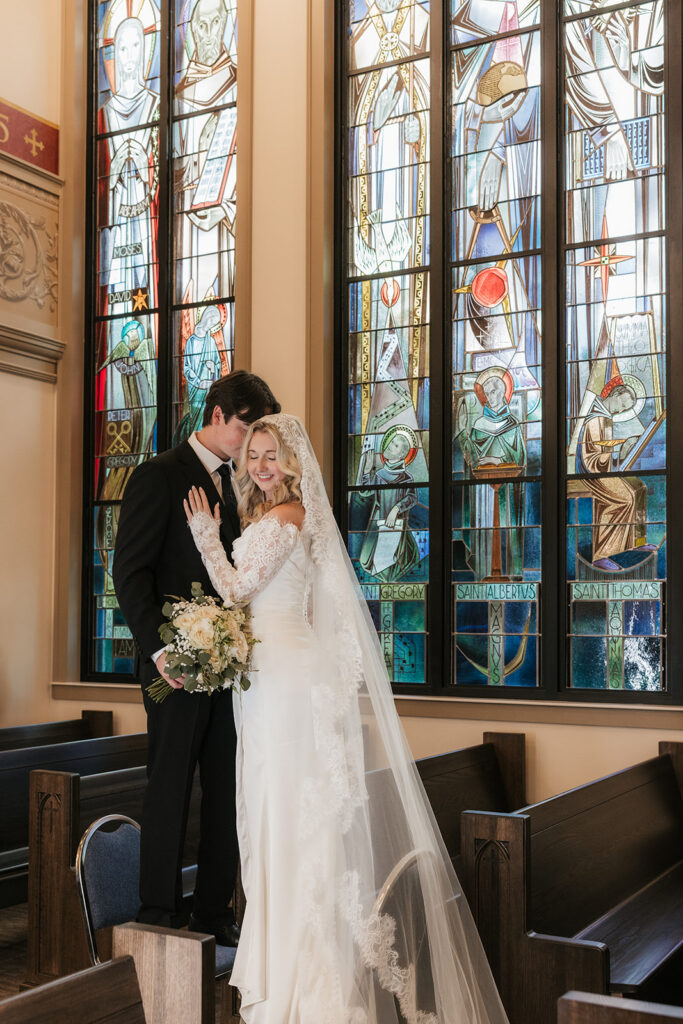 groom kissing the bride on the cheek
