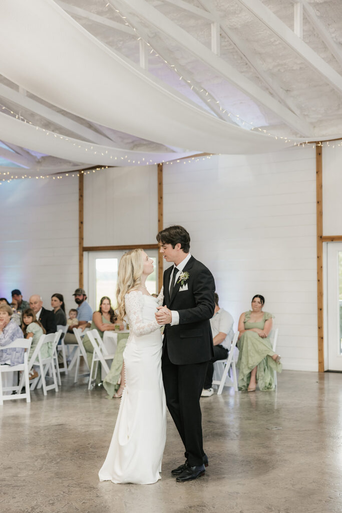 bride and groom smiling at each other