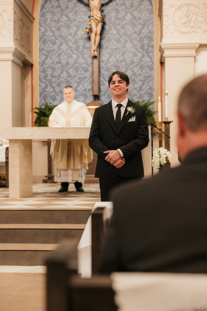 groom emotional watching the bride walking down the aisle