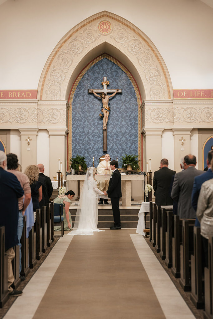 bride and groom holding hands during their wedding ceremony