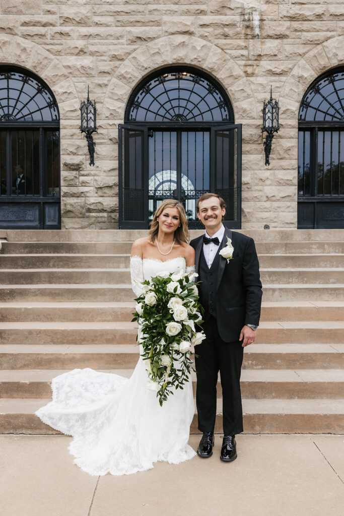 cute picture of the newlyweds smiling at the camera