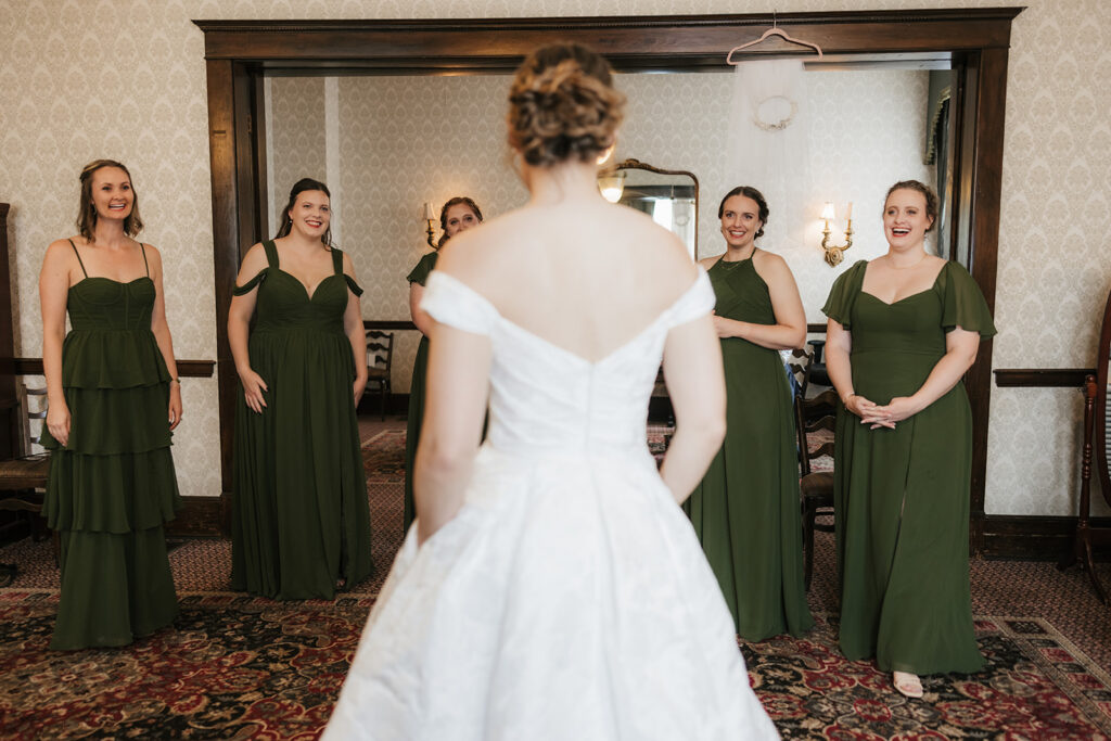 bride and her bridesmaids emotional during their first look