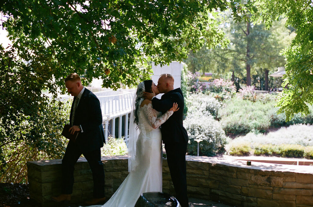 newlyweds kissing after their wedding ceremony