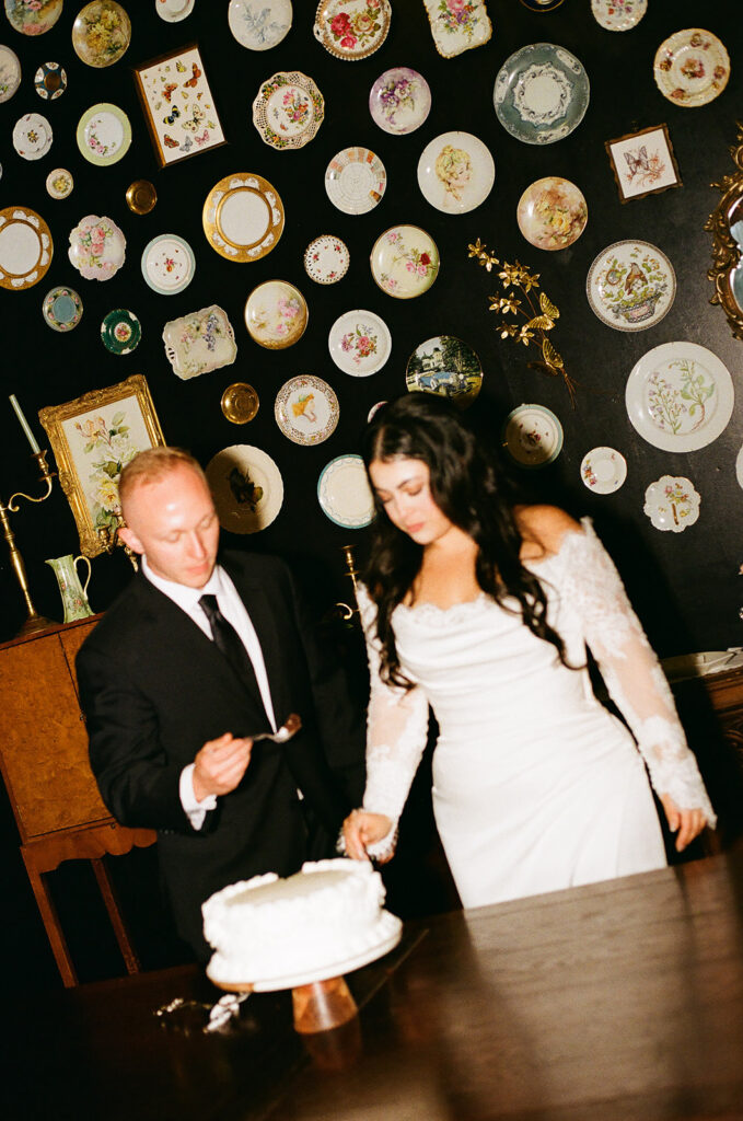 cute picture of the newlyweds cutting their wedding cake