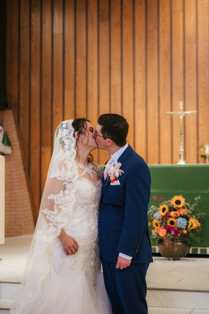 cute picture of the bride and groom kissing during their photoshoot