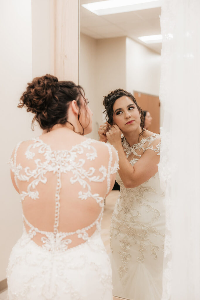 Bride putting on her jewelry before the ceremony