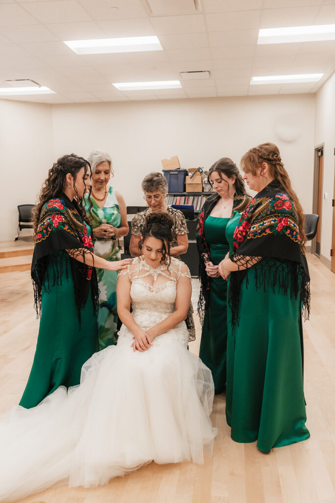 Cute picture of the bridesmaids praying for the bride