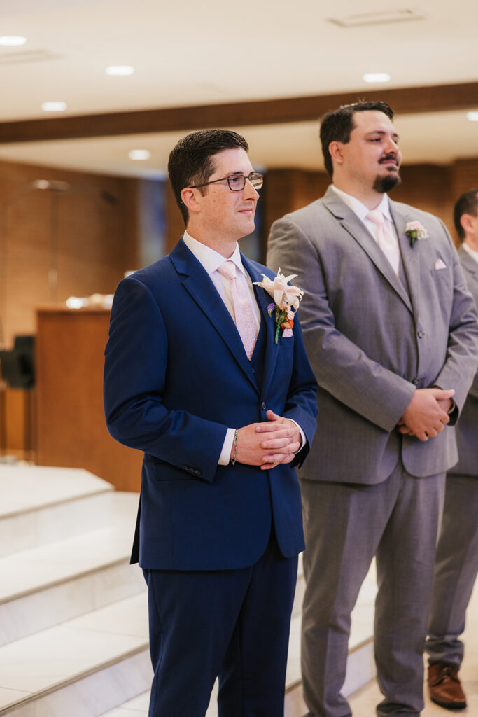 Groom emotional, watching the bride walk down the aisle